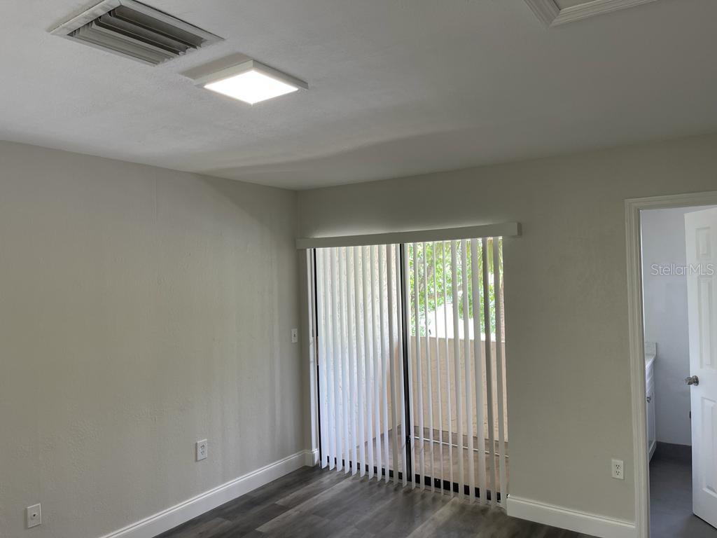 10260 Turkey Lake Road, Unit 150 (A30) Orlando, FL 32819 - Photo 6 of 13 a view of empty room with wooden floor and fan