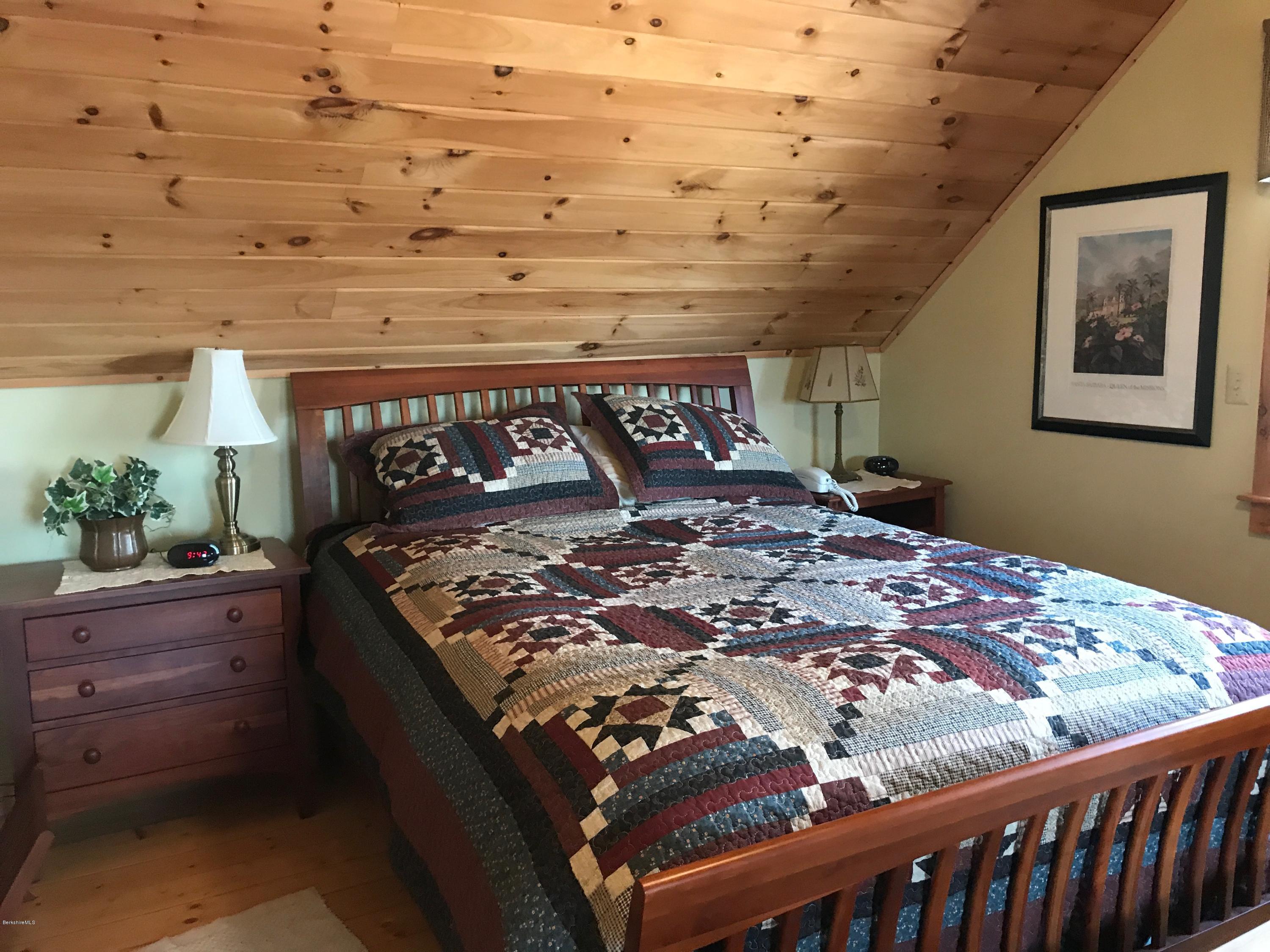 128 Branch Hill Road Heath, MA 01346 - Photo 11 of 30 a bed sitting in a bedroom next to a window