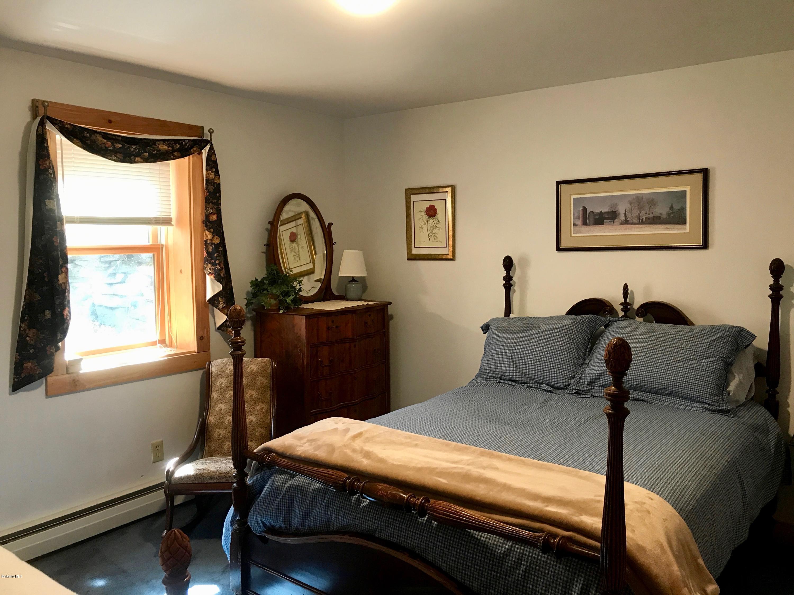 128 Branch Hill Road Heath, MA 01346 - Photo 19 of 30 a bed room with a bed and a table
