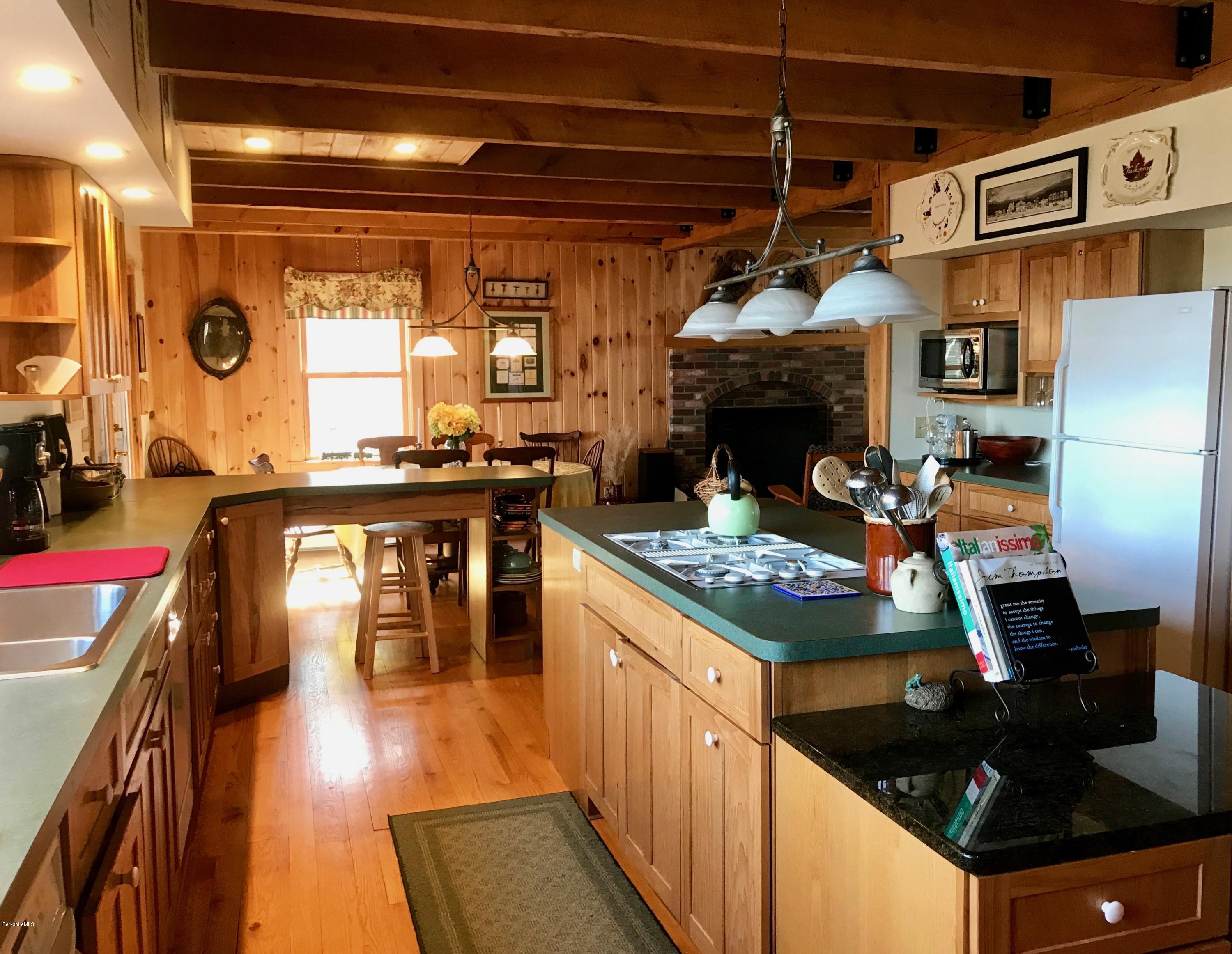 128 Branch Hill Road Heath, MA 01346 - Photo 5 of 30 a kitchen with stainless steel appliances granite countertop a stove a refrigerator a dining table and chairs with wooden floor