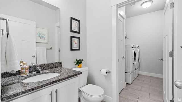 111 East Silver Oak Road Vineyard, UT 84059 - Photo 15 of 50 Bathroom featuring a white vanity with a dark speckled countertop, an oval undermount sink, and a chrome faucet