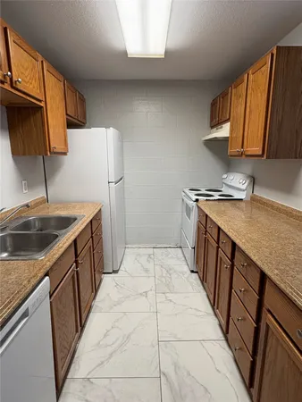 a kitchen with a sink stove and cabinets