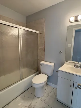 a white toilet sitting next to a bathroom sink