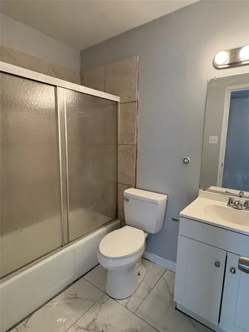 a white toilet sitting next to a bathroom sink