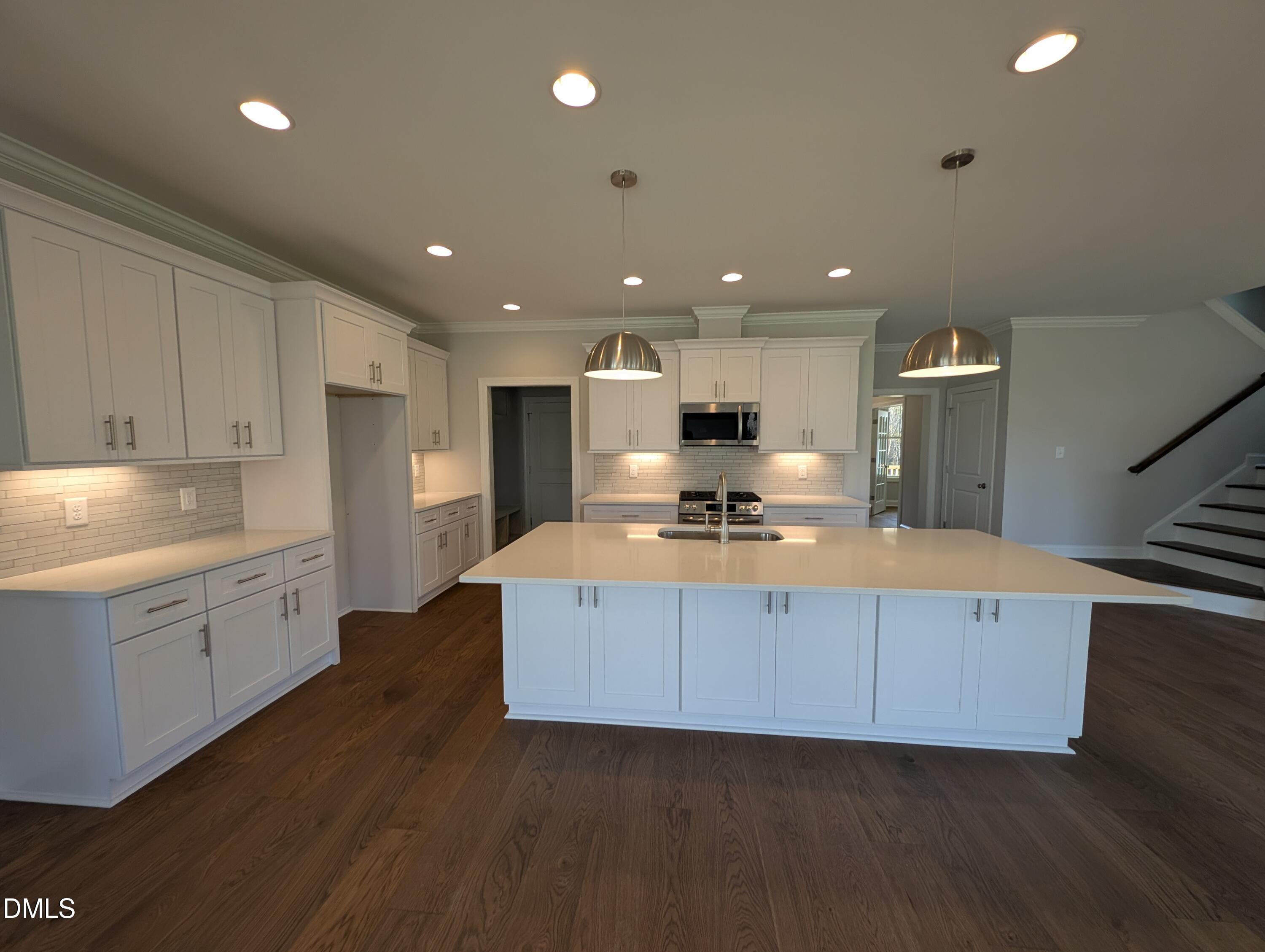2818 John Lewis Road Burlington, NC 27217 - Photo 14 of 62 a large kitchen with stainless steel appliances a large counter top a stove and a refrigerator