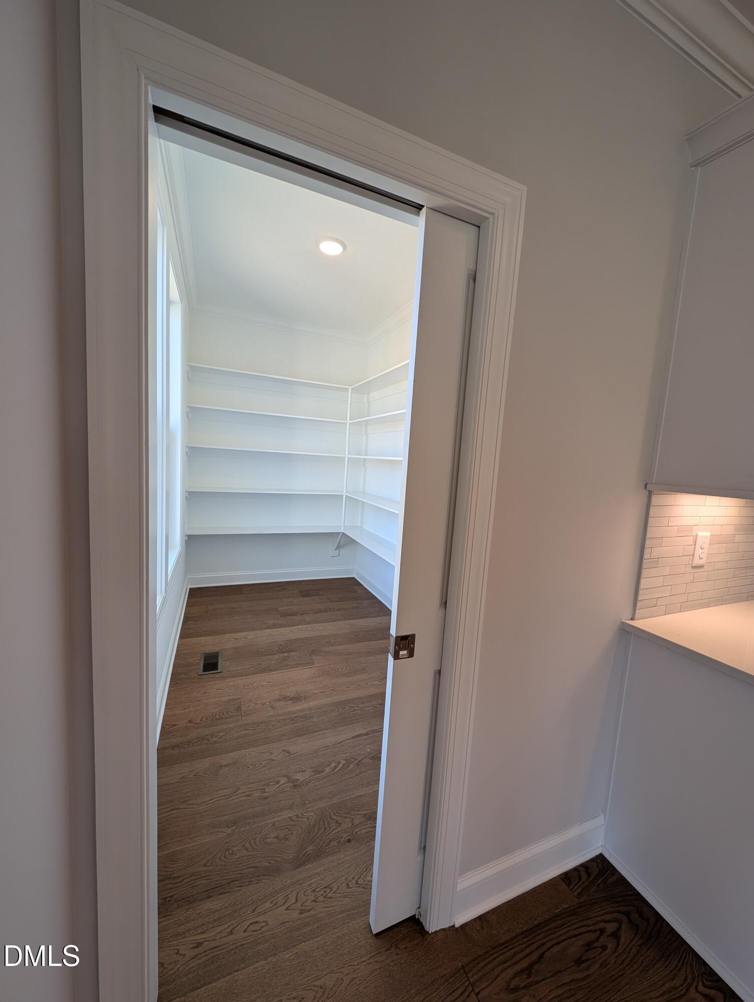2818 John Lewis Road Burlington, NC 27217 - Photo 16 of 62 a view of walk in closet with wooden floor