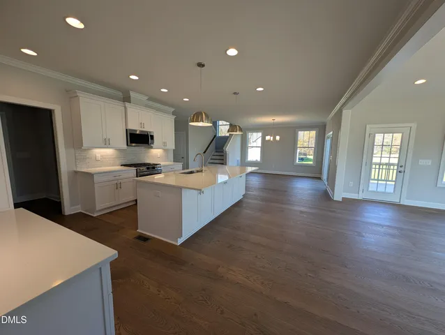 a kitchen with stainless steel appliances granite countertop a stove and a refrigerator