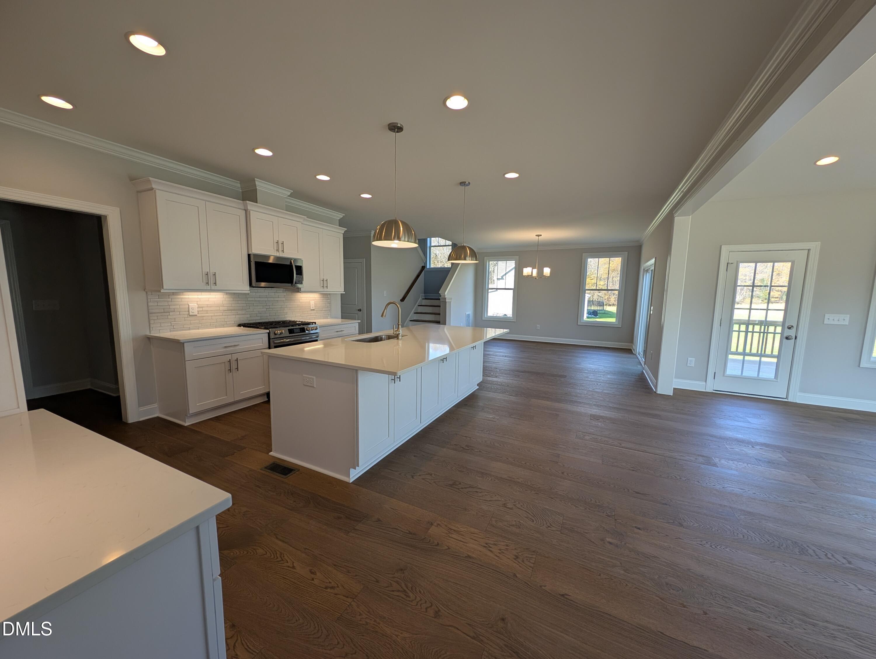 2818 John Lewis Road Burlington, NC 27217 - Photo 17 of 62 a large kitchen with cabinets wooden floor and stainless steel appliances