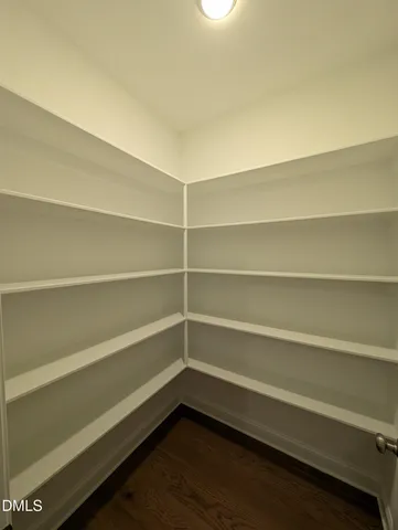 an empty room with a window and a ceiling fan