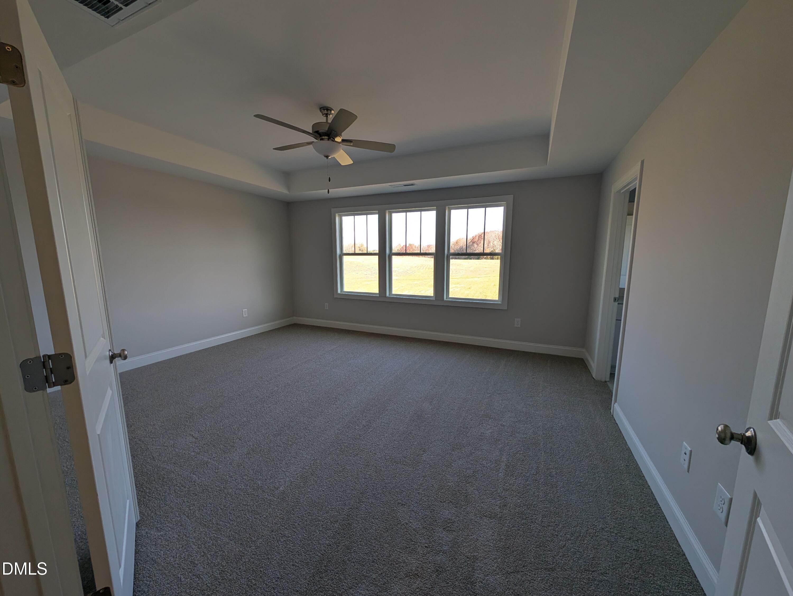 2818 John Lewis Road Burlington, NC 27217 - Photo 31 of 62 an empty room with a window and a ceiling fan