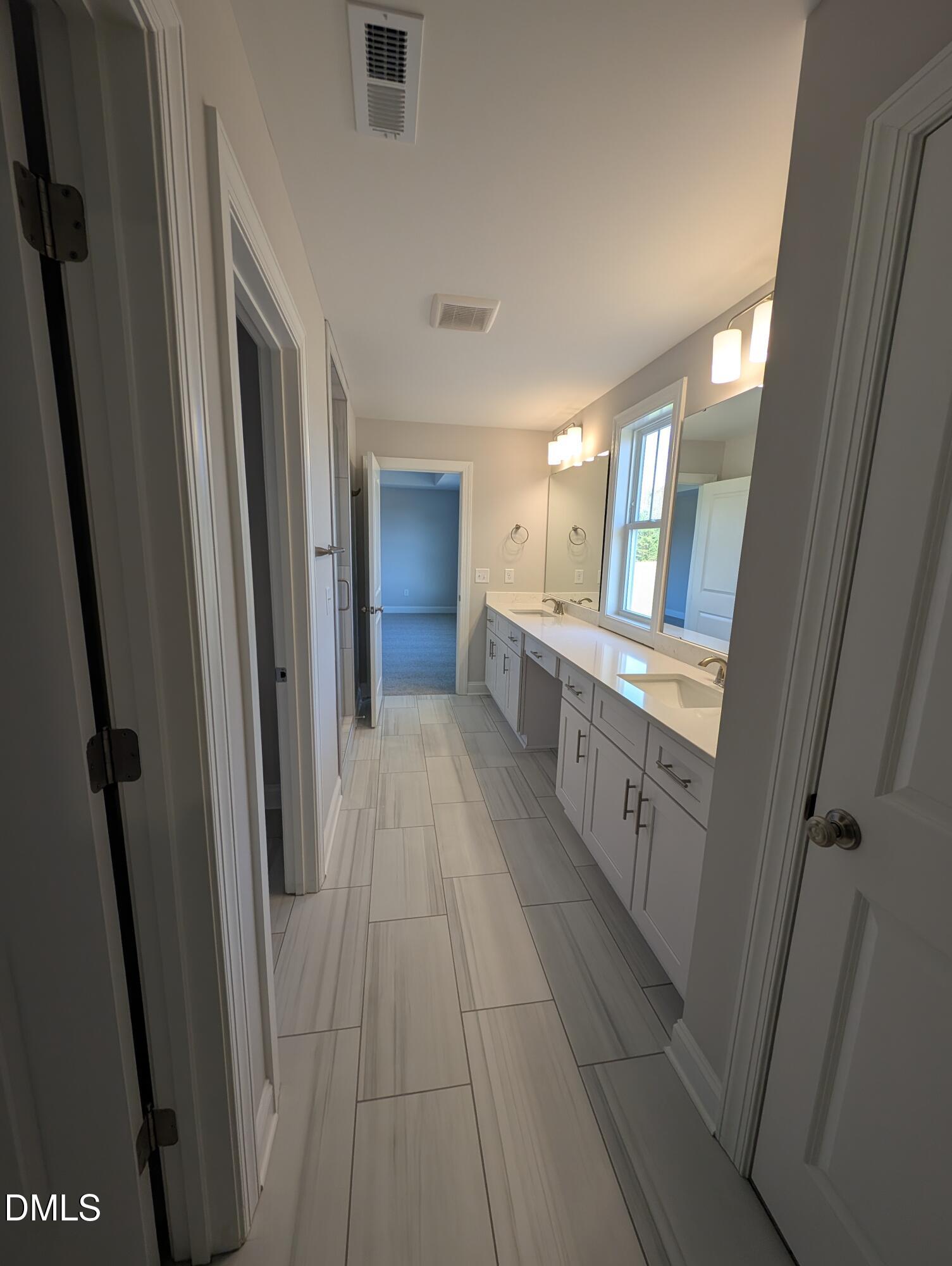 2818 John Lewis Road Burlington, NC 27217 - Photo 39 of 62 a bathroom with a double vanity sink and a mirror