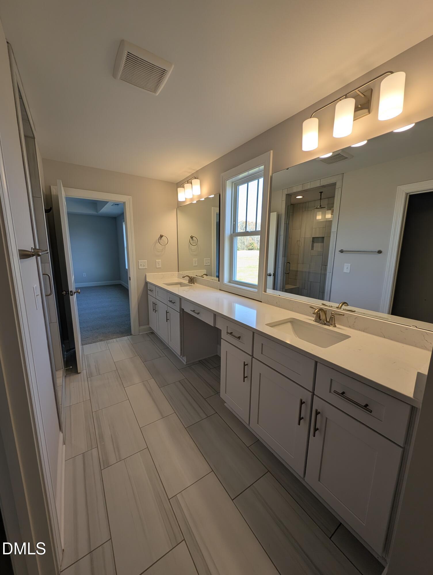 2818 John Lewis Road Burlington, NC 27217 - Photo 40 of 62 a large bathroom with a double vanity sink and a mirror