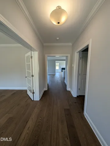 a view of a room with wooden floor staircase and a living room