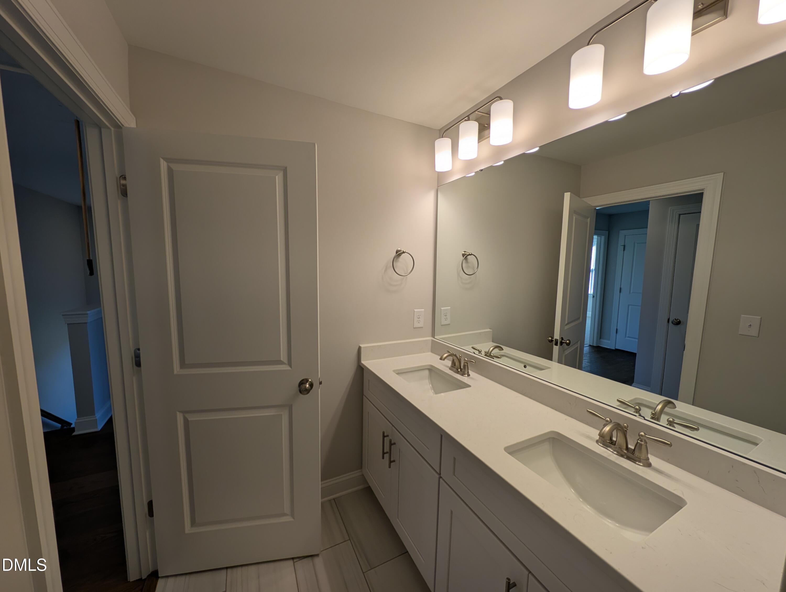 2818 John Lewis Road Burlington, NC 27217 - Photo 46 of 62 a bathroom with a double vanity sink and mirror