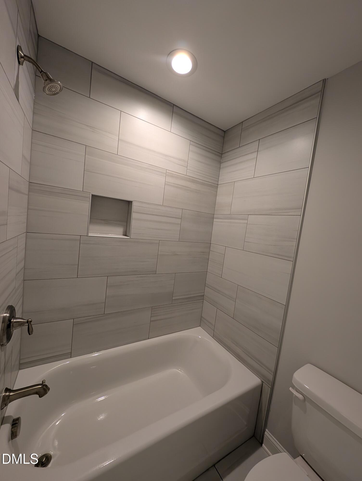 2818 John Lewis Road Burlington, NC 27217 - Photo 47 of 62 a bathroom with a bathtub and a toilet