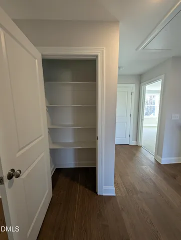 a view of a field with an trees in the background