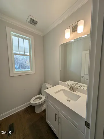 a bathroom with a sink toilet and a mirror