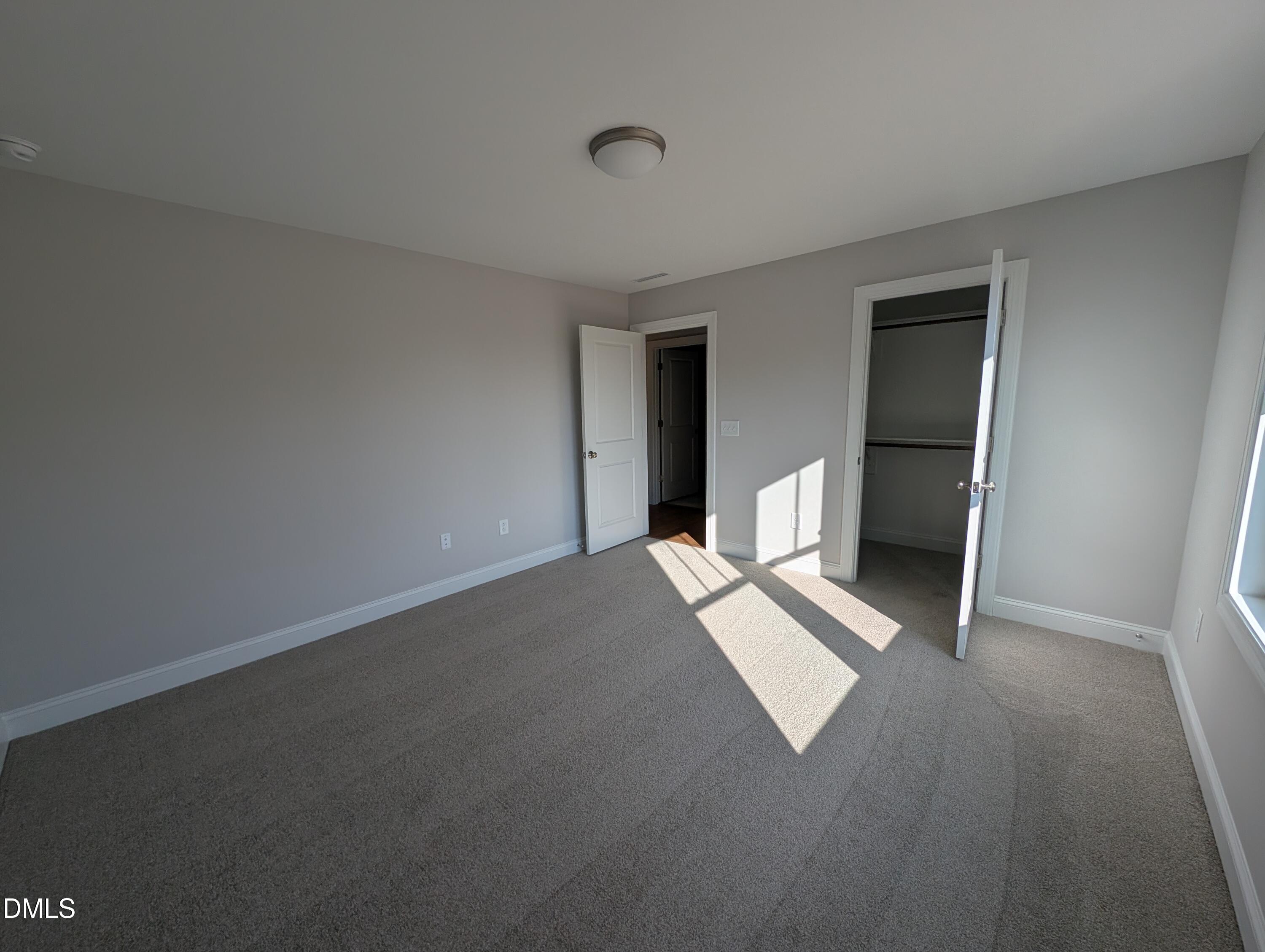 2818 John Lewis Road Burlington, NC 27217 - Photo 51 of 62 a view of an empty room with wooden floor and a window