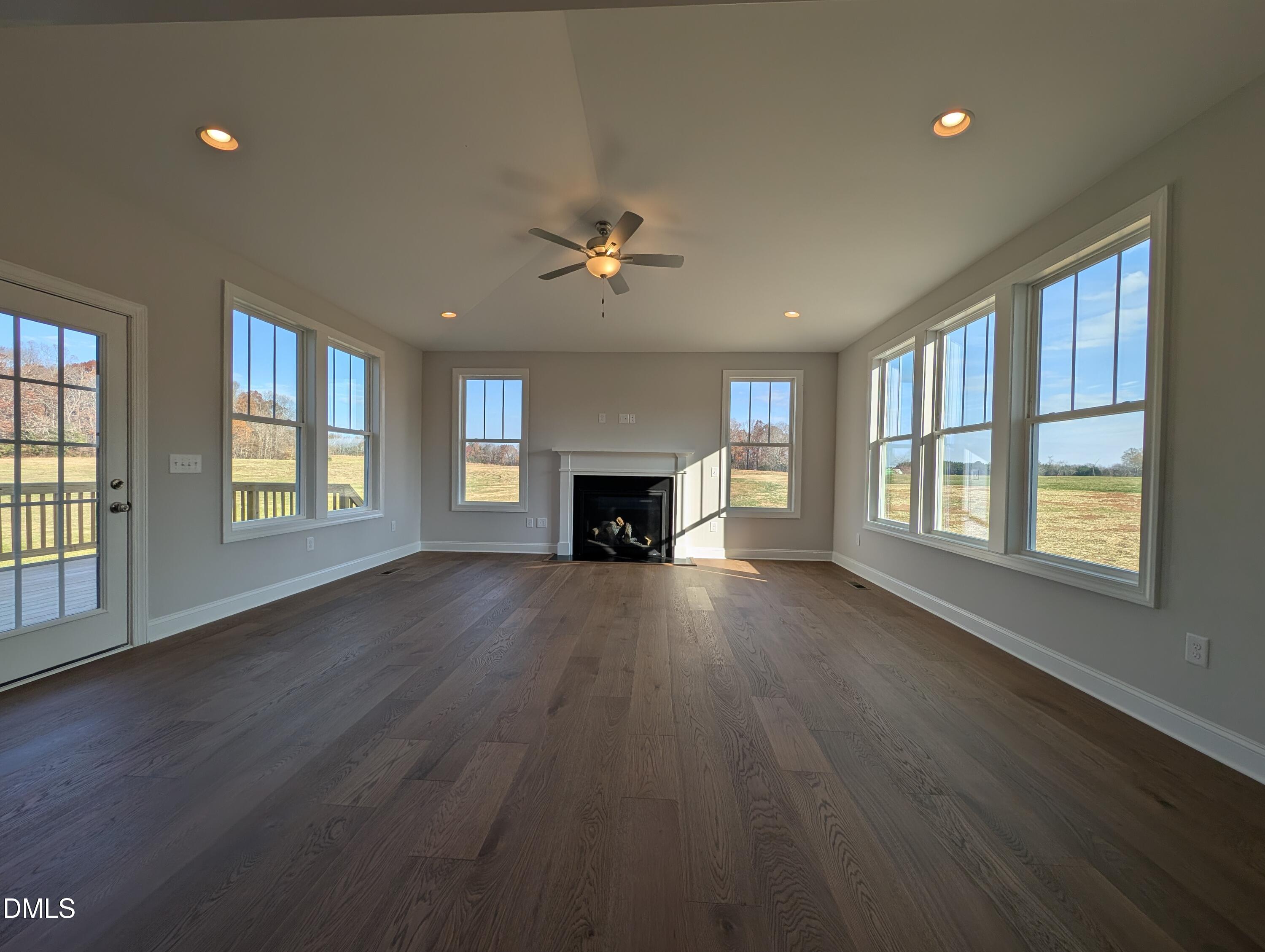 2818 John Lewis Road Burlington, NC 27217 - Photo 9 of 62 a view of an empty room with wooden floor and a window