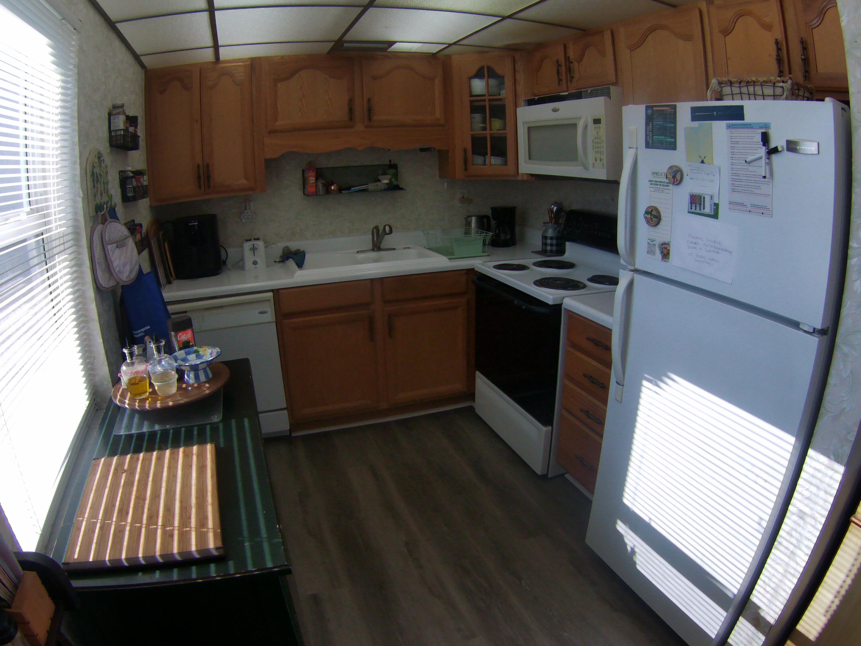 571 Capri L Delray Beach, FL 33484 - Photo 12 of 33 a kitchen with cabinets and wooden floor