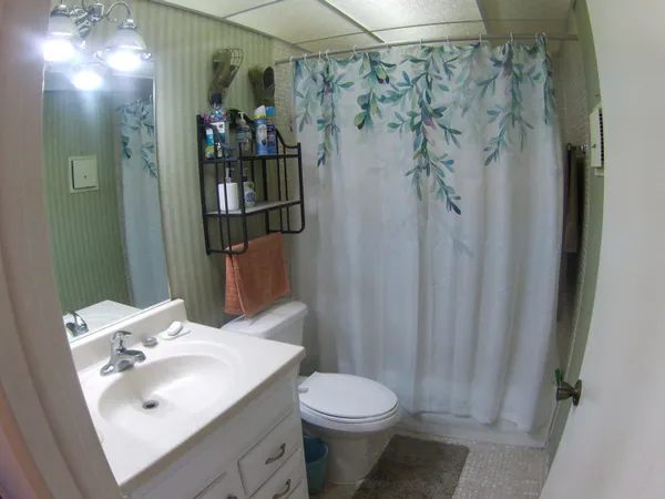 a bathroom with a toilet and a shower