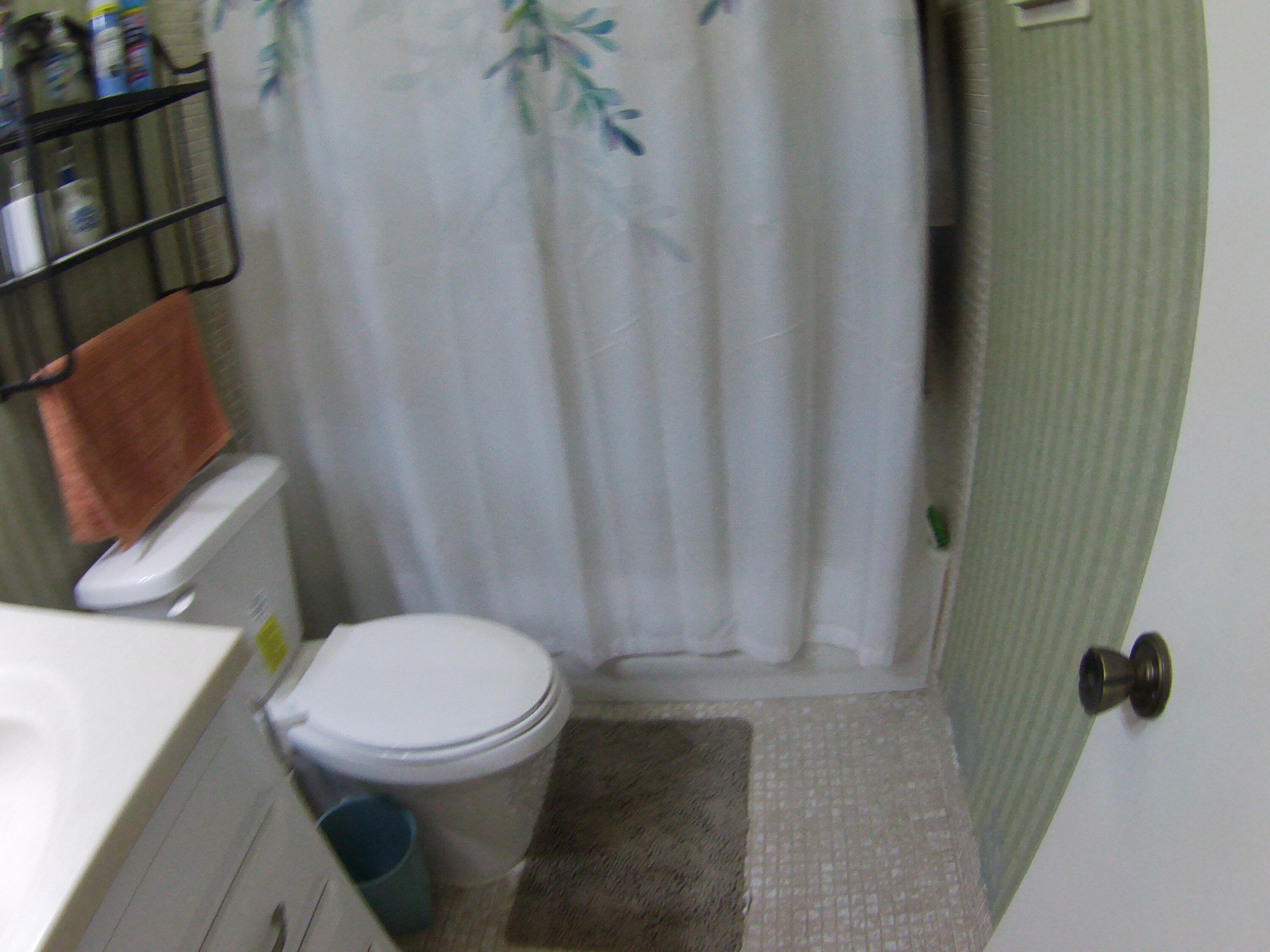 571 Capri L Delray Beach, FL 33484 - Photo 15 of 33 a bathroom with a toilet and a shower