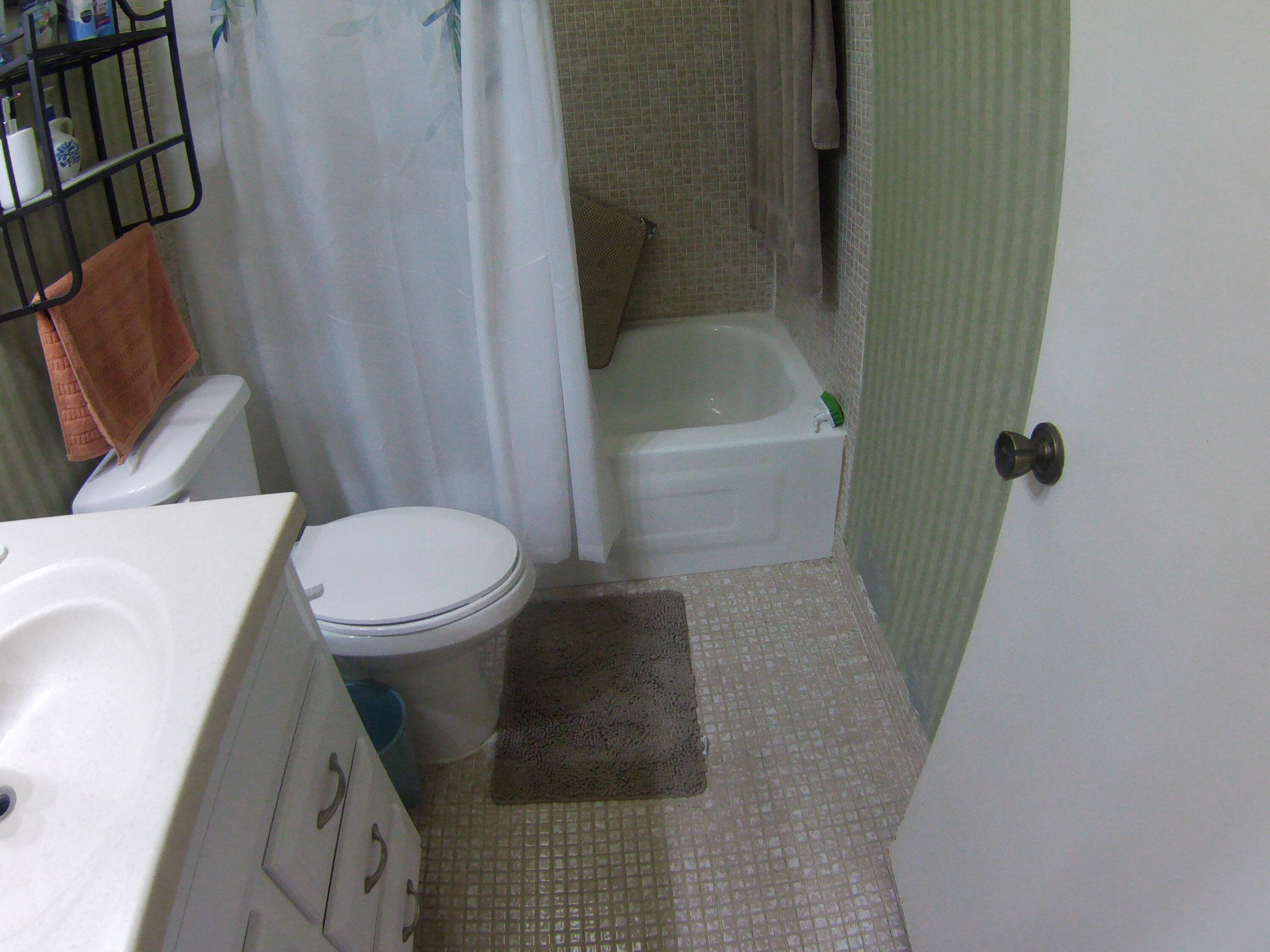 571 Capri L Delray Beach, FL 33484 - Photo 16 of 33 a bathroom with a sink and toilet