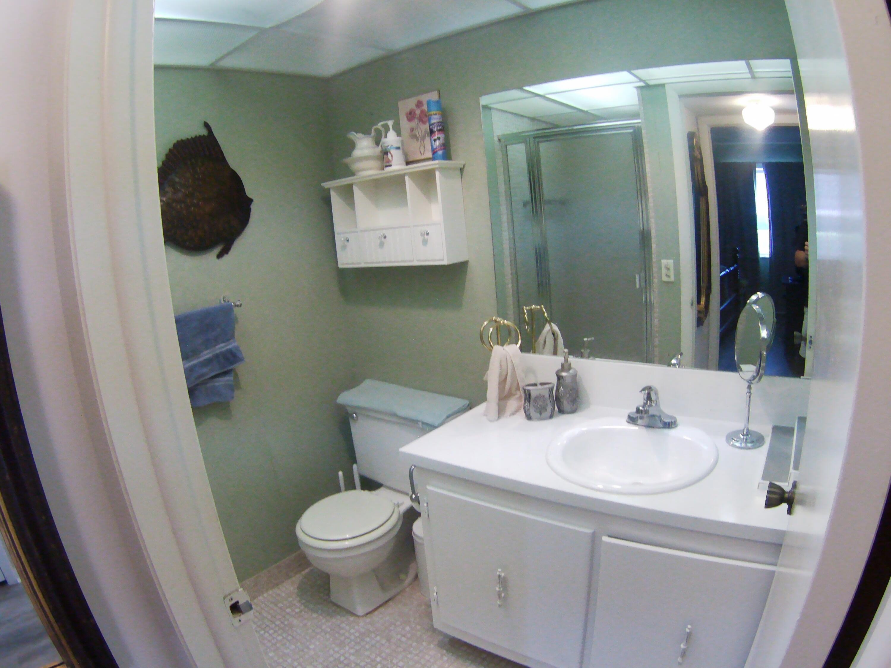 571 Capri L Delray Beach, FL 33484 - Photo 20 of 33 a bathroom with a toilet sink and mirror