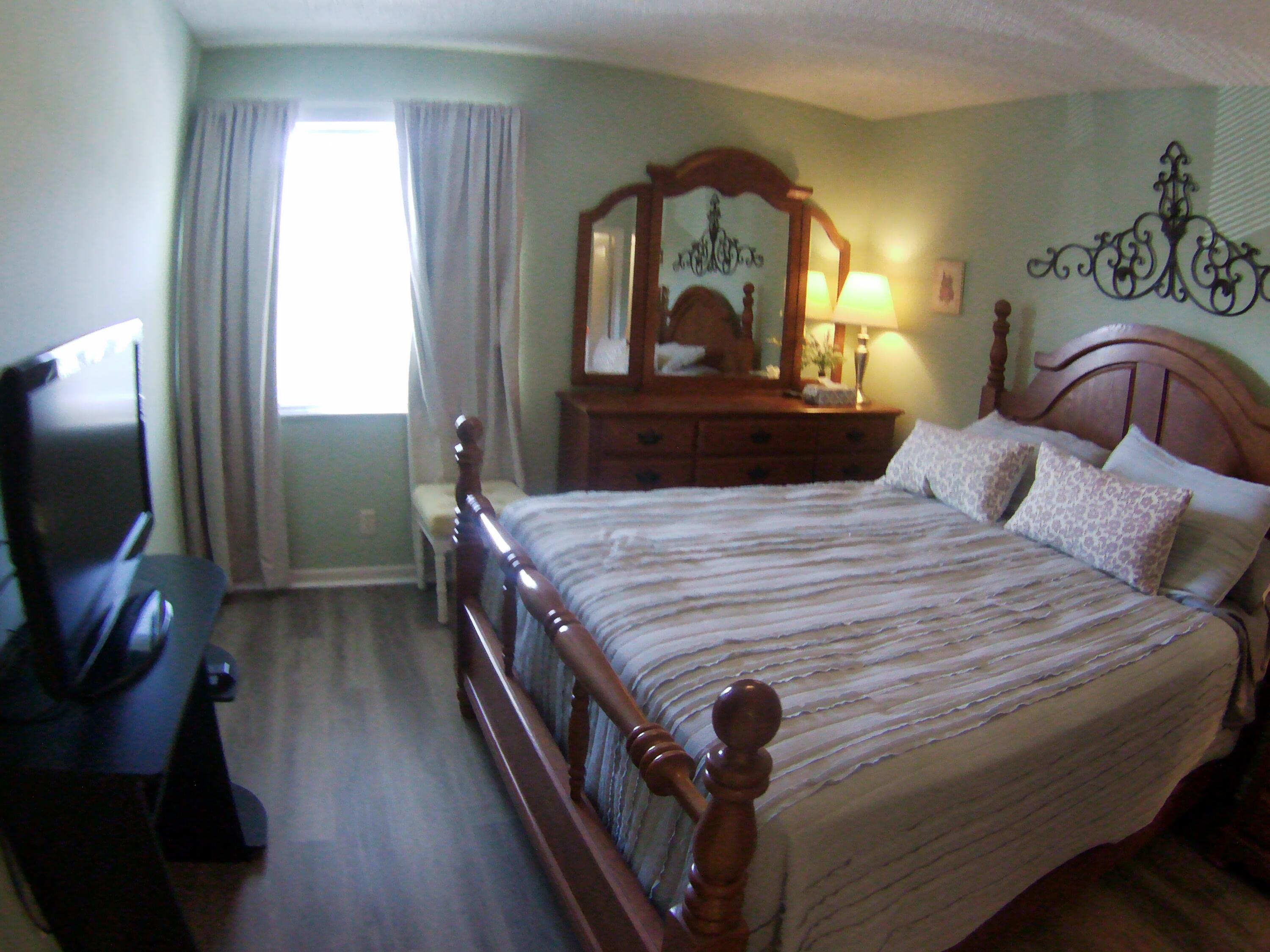 571 Capri L Delray Beach, FL 33484 - Photo 24 of 33 a bedroom with a bed and a mirror on dresser