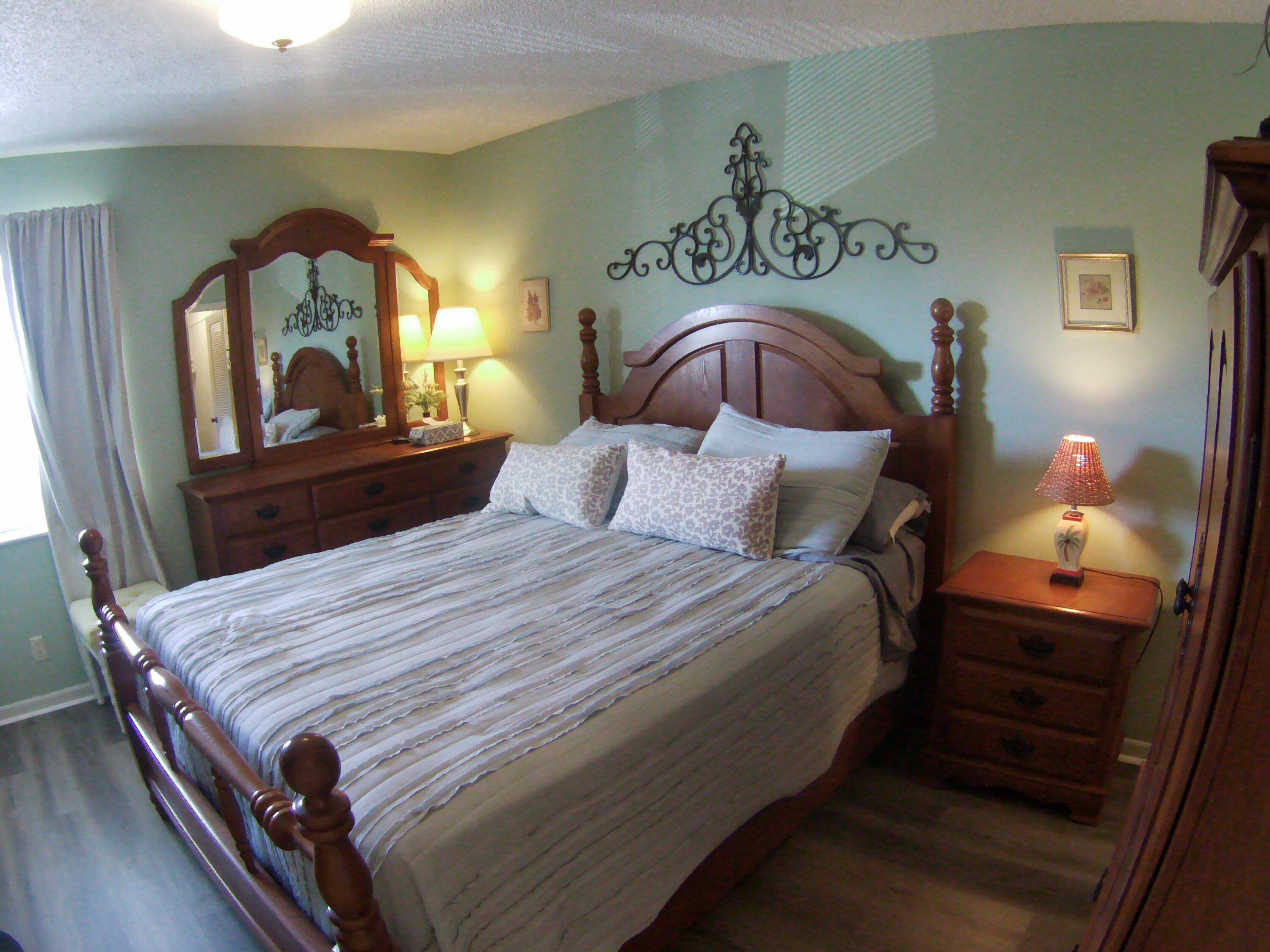 571 Capri L Delray Beach, FL 33484 - Photo 25 of 33 a bedroom with a bed and a mirror on dresser