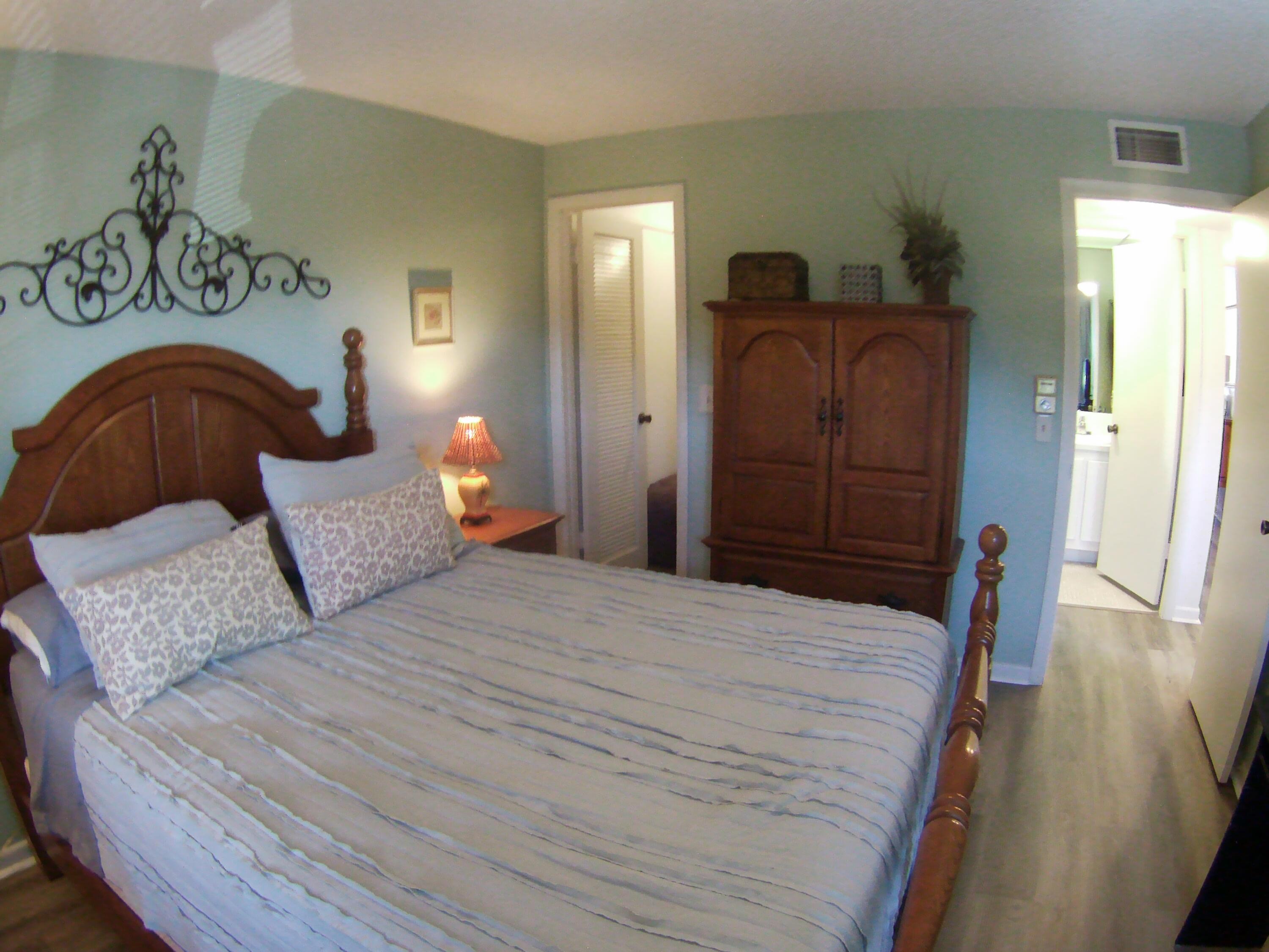 571 Capri L Delray Beach, FL 33484 - Photo 26 of 33 a bedroom with a bed and wooden floor
