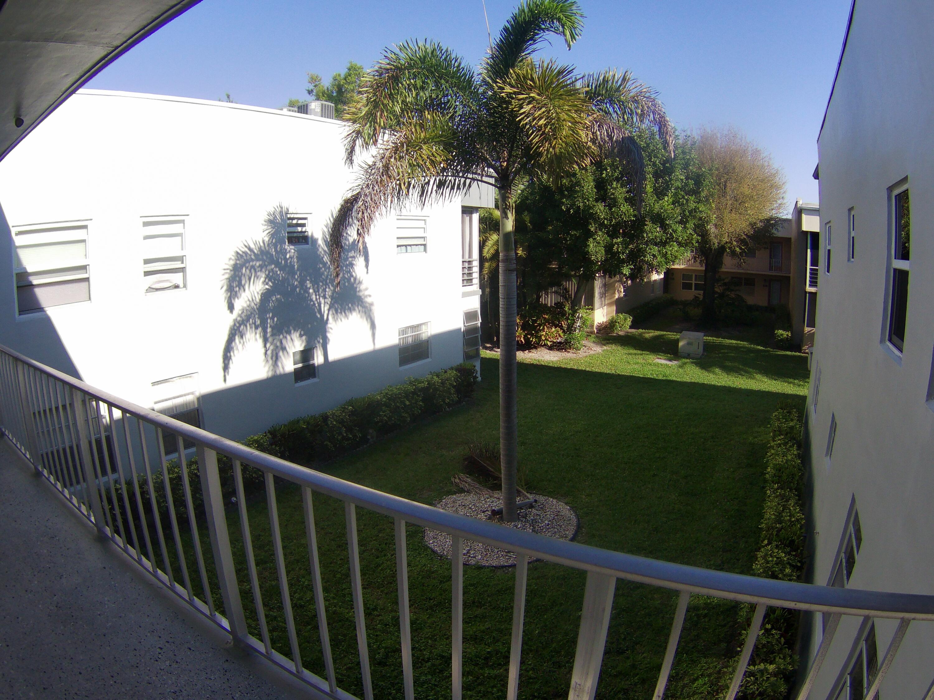 571 Capri L Delray Beach, FL 33484 - Photo 3 of 33 a view of a balcony with floor to ceiling windows and wooden fence