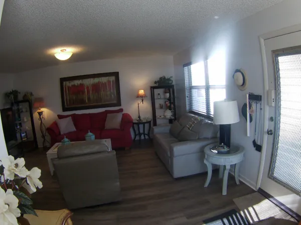 a view of a room with furniture and window