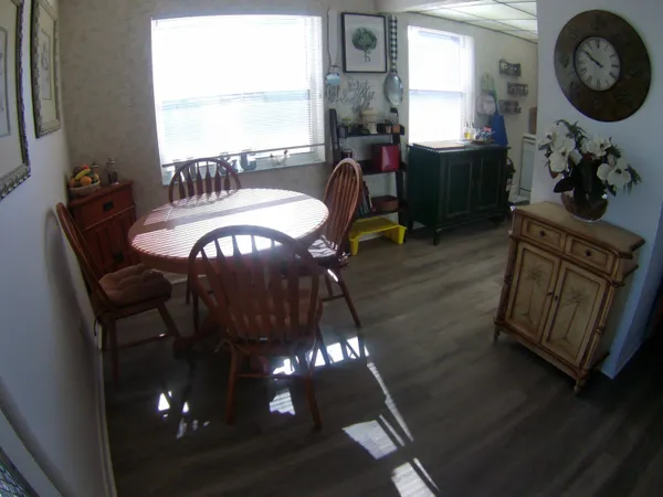 a view of a dining room with furniture and chandelier