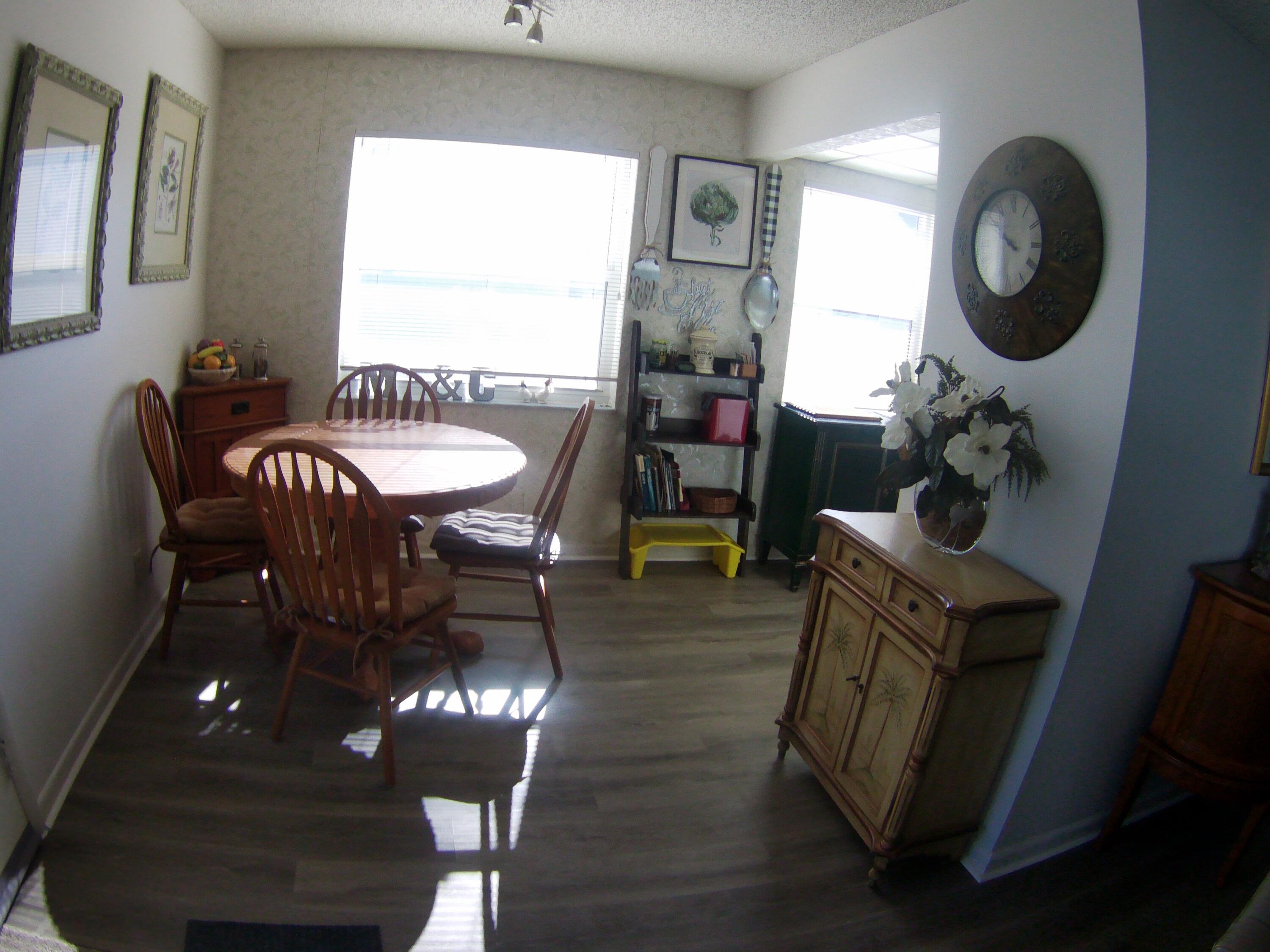 571 Capri L Delray Beach, FL 33484 - Photo 9 of 33 a view of a dining room with furniture and chandelier