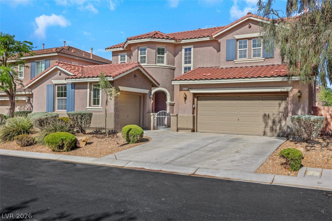 10328 Hawk Ravine Street Las Vegas, NV 89178 - Photo 3 of 55 A charming stucco home with a terracotta tile roof and dual garages welcomes you from the curb.