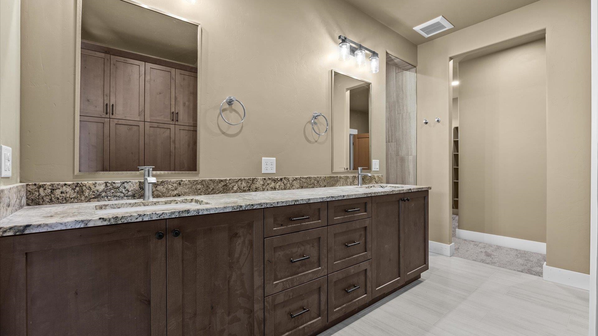 1193 22 1/2 Road Grand Junction, CO 81505 - Photo 13 of 28 a bathroom with a granite countertop sink double and mirror