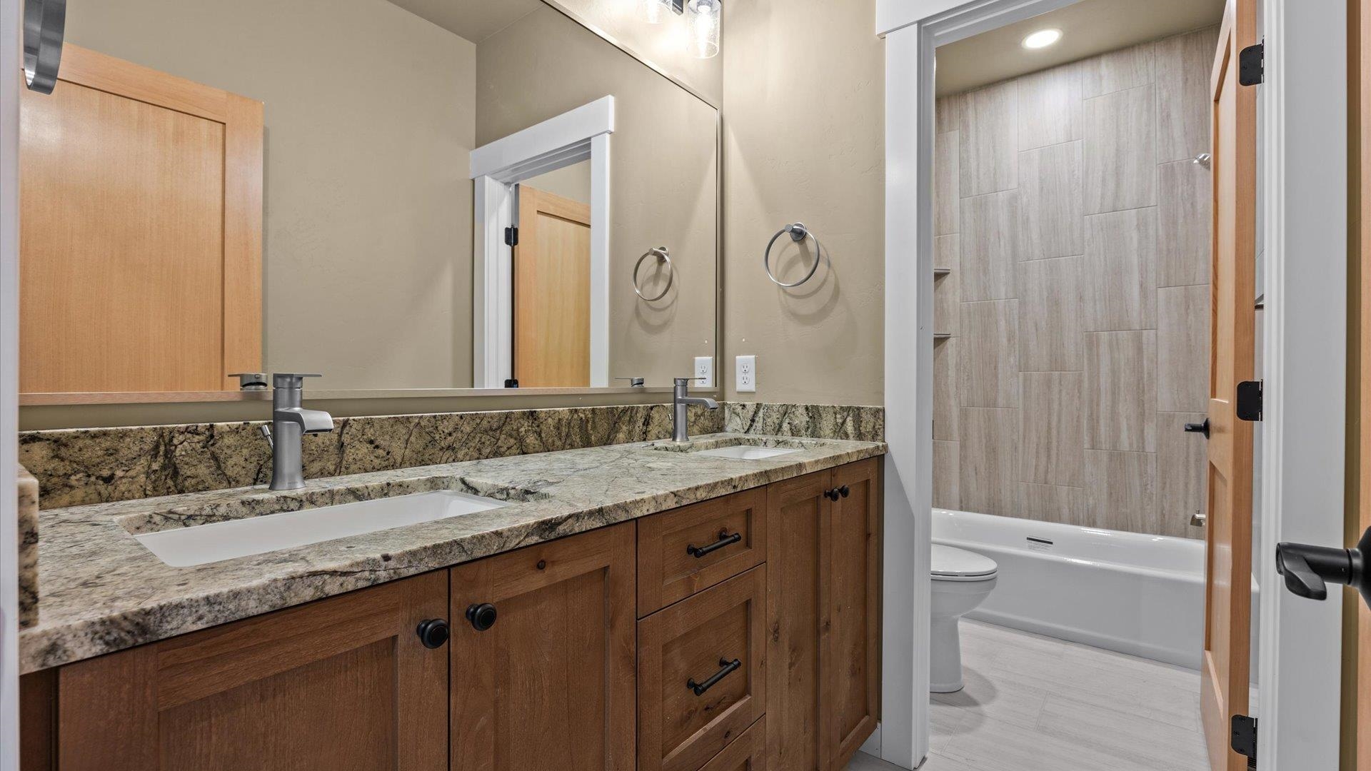 1193 22 1/2 Road Grand Junction, CO 81505 - Photo 21 of 28 a bathroom with a granite countertop sink and a mirror