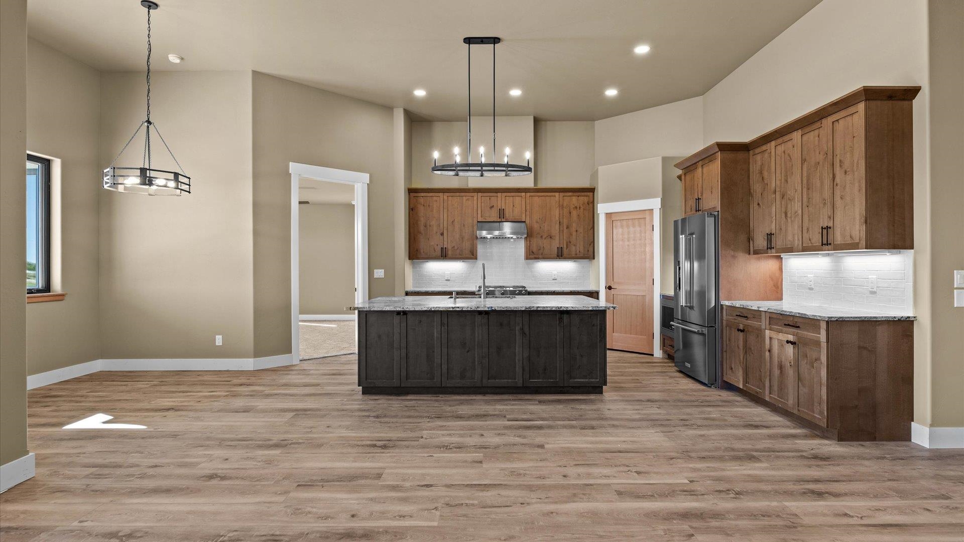 1193 22 1/2 Road Grand Junction, CO 81505 - Photo 8 of 28 a large kitchen with granite countertop a large counter top stainless steel appliances and cabinets