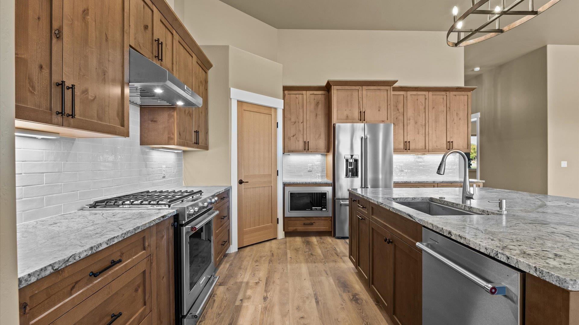 1193 22 1/2 Road Grand Junction, CO 81505 - Photo 10 of 28 a kitchen with stainless steel appliances granite countertop a sink stove and refrigerator