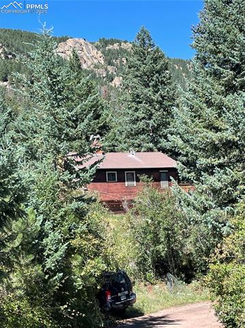 9355 Shoshone Road Cascade, CO 80809 - Photo 1 of 1 View of mountain feature with a forest view