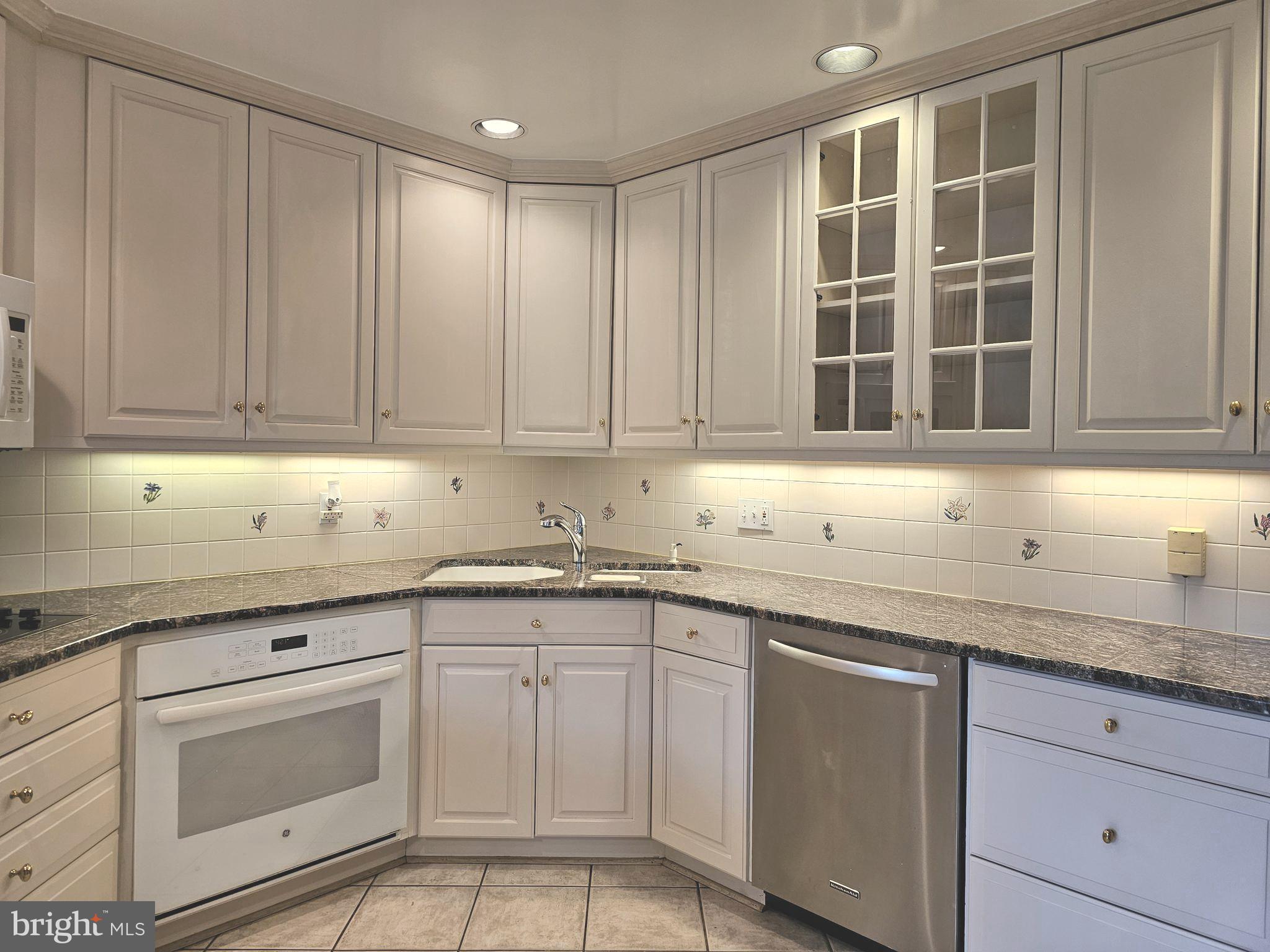 851 Canal Drive McLean, VA 22102 - Photo 12 of 50 a kitchen with granite countertop stainless steel appliances white cabinets sink and dishwasher