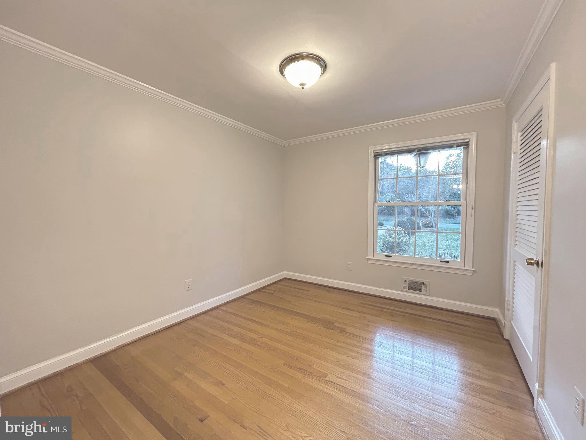 851 Canal Drive McLean, VA 22102 - Photo 21 of 50 an empty room with wooden floor and windows
