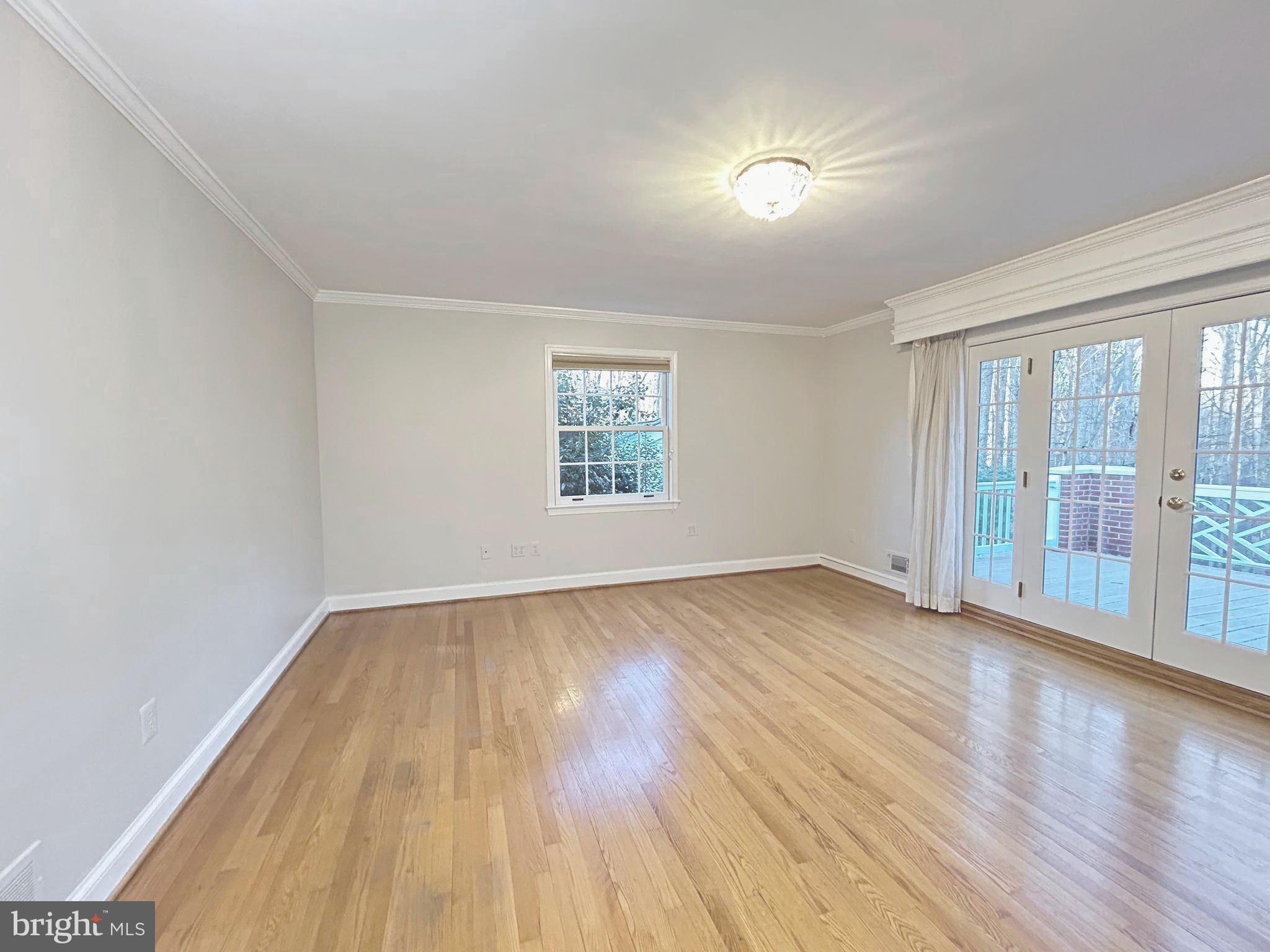 851 Canal Drive McLean, VA 22102 - Photo 23 of 50 an empty room with wooden floor and windows
