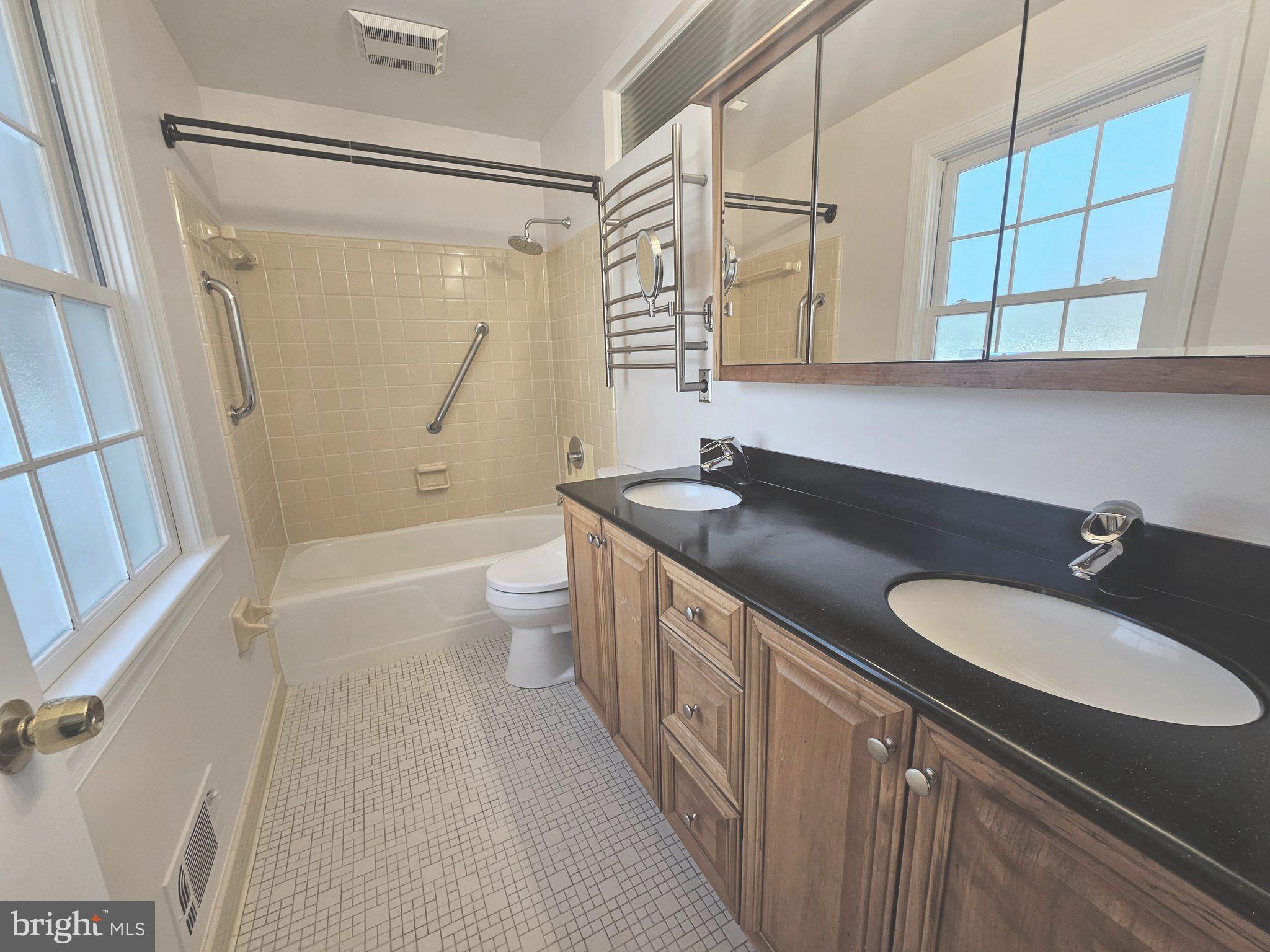 851 Canal Drive McLean, VA 22102 - Photo 24 of 50 a bathroom with a granite countertop sink a toilet a mirror and shower