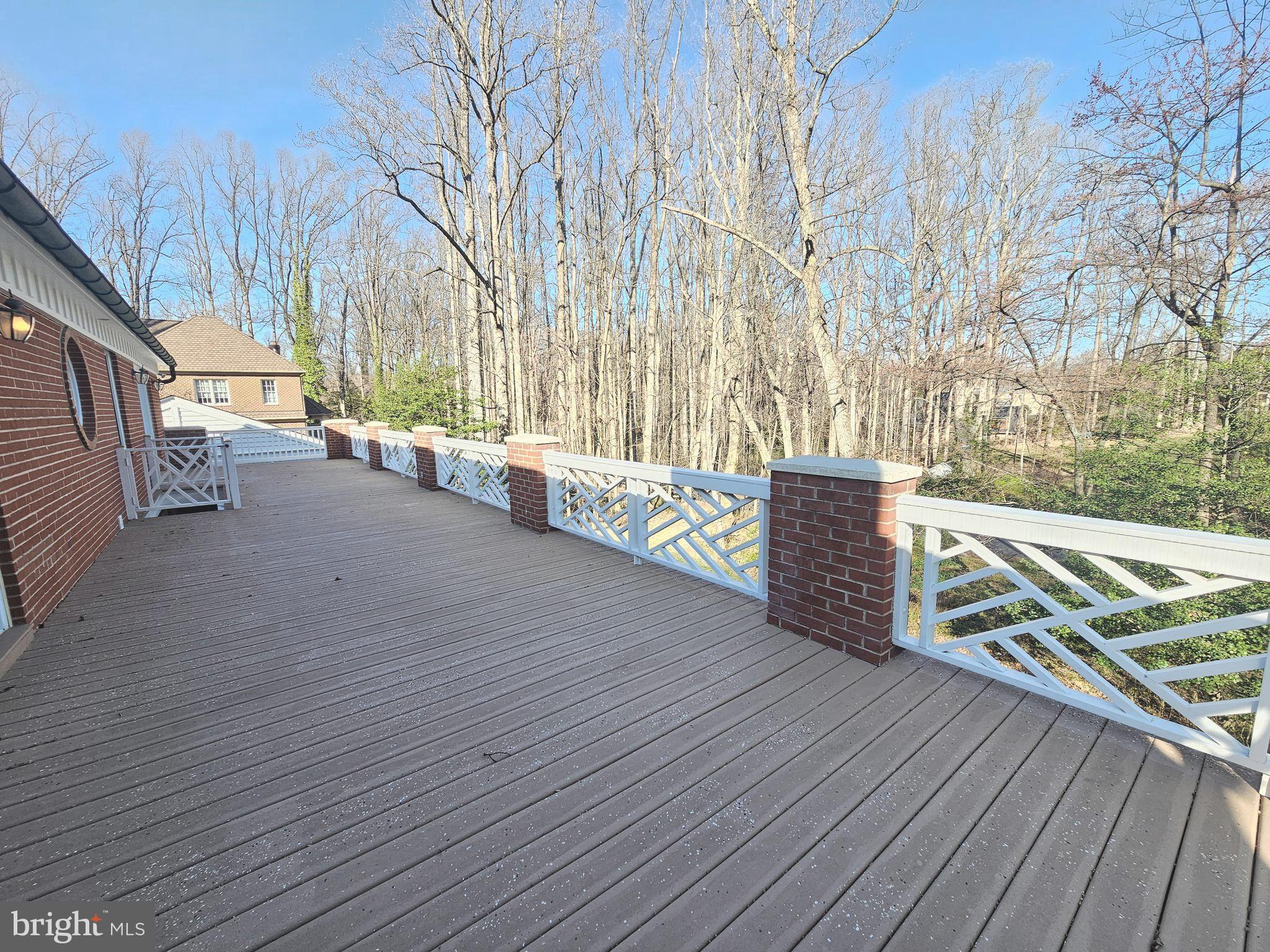 851 Canal Drive McLean, VA 22102 - Photo 35 of 50 a view of a deck with wooden floor and fence next to a yard
