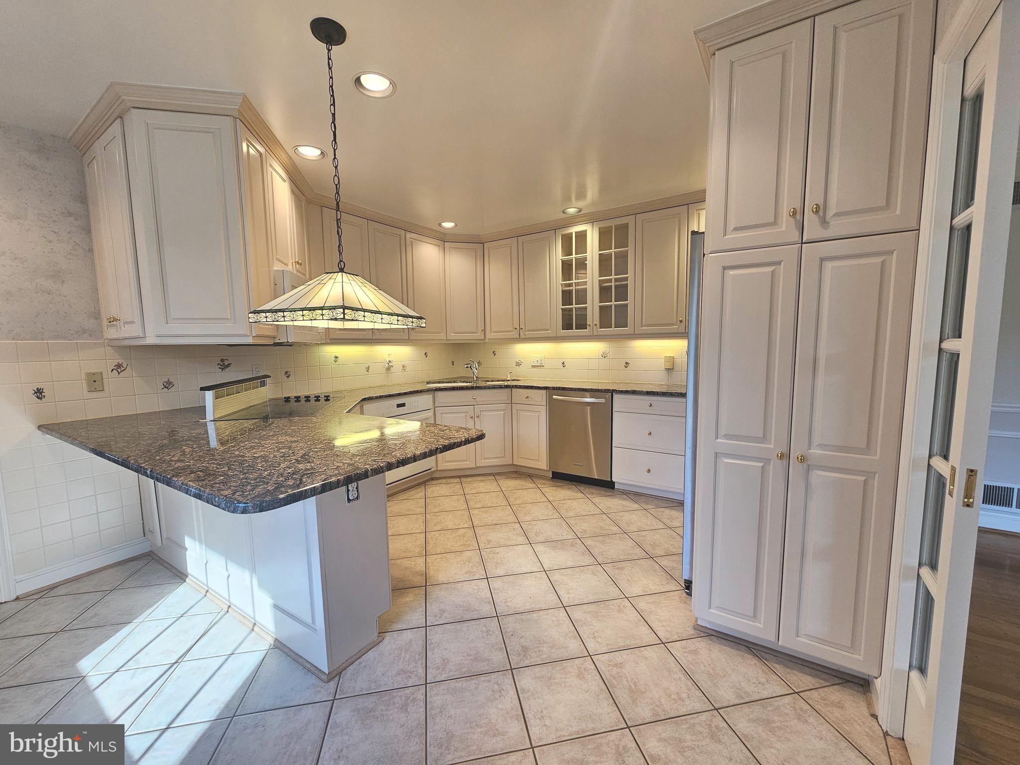 851 Canal Drive McLean, VA 22102 - Photo 10 of 50 a kitchen with stainless steel appliances granite countertop a sink and a refrigerator