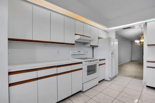 a kitchen with stainless steel appliances granite countertop a sink and a stove