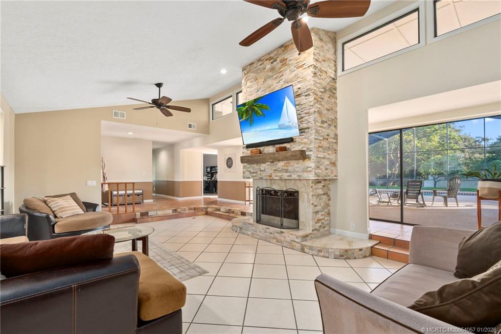 4599 Southeast Halston Court Stuart, FL 34997 - Photo 16 of 65 a living room with furniture fireplace and flat screen tv