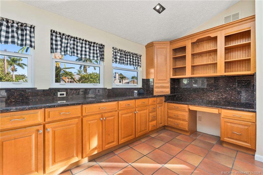 4599 Southeast Halston Court Stuart, FL 34997 - Photo 27 of 65 a kitchen with stainless steel appliances granite countertop a sink and cabinets